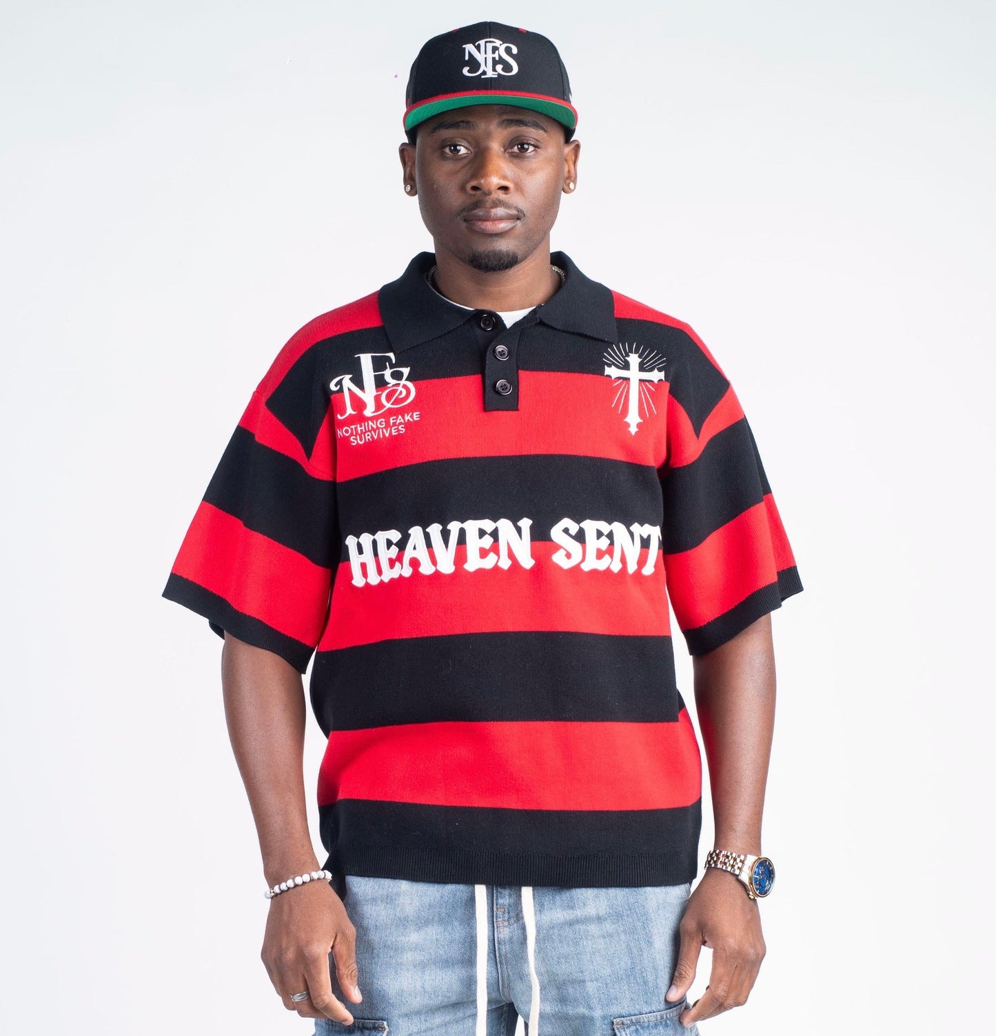Man wearing a red and black striped shirt with 'Heaven Sent' text, standing against a white background