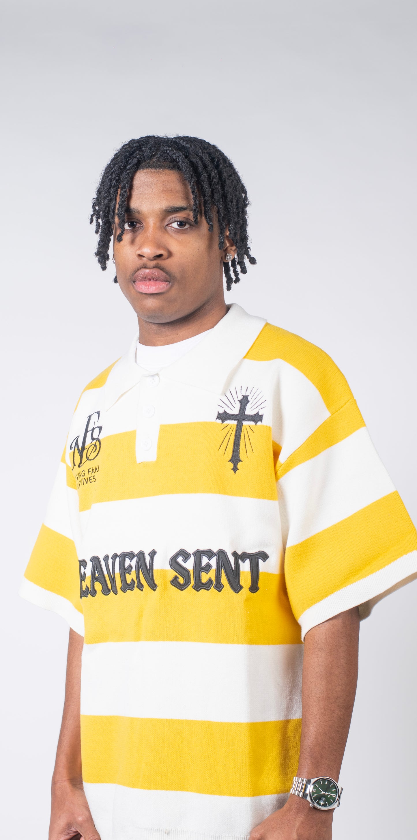 Person wearing a yellow and white striped shirt with text on a plain background